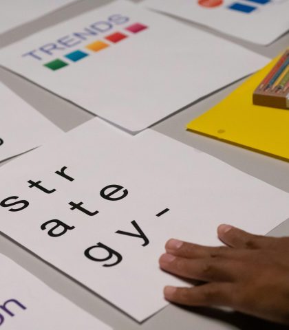 Close-up of marketing strategy notes and colorful trends sheet on a table for planning session.
