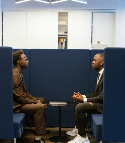 Two professionals in a modern office setting discussing business strategies.